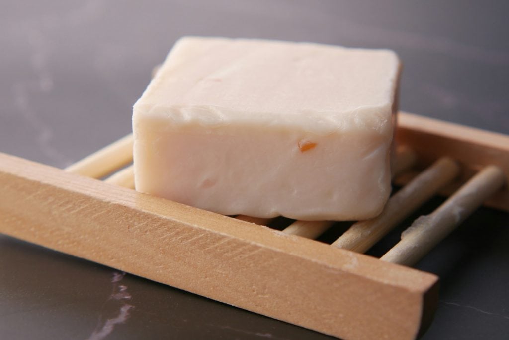 a block of soap sitting on top of chopsticks